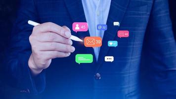 People using social media and digital online marketing concepts with icons such as notifications, messages, comments on the screen. photo