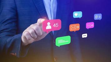 People using social media and digital online marketing concepts with icons such as notifications, messages, comments on the screen. photo