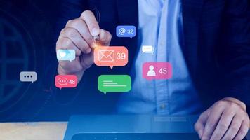 People using social media and digital online marketing concepts on laptop with icons such as notifications, messages, comments on the smartphone screen. photo