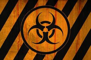 Biohazard symbol on a striped painted concrete wall photo