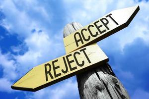 Accept, Reject - Wooden Signpost with Two Arrows and Sky in Background photo