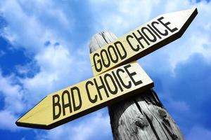 Good Choice, Bad Choice - Wooden Signpost with Two Arrows and Sky in Background photo