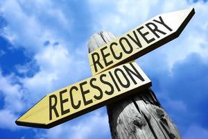 Recovery, Recession - Wooden Signpost with Two Arrows and Sky in Background photo