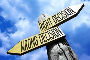 Right Decision, Wrong Decision - Wooden Signpost with Two Arrows and Sky in Background photo