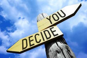 You Decide - Wooden Signpost with Two Arrows and Sky in Background photo