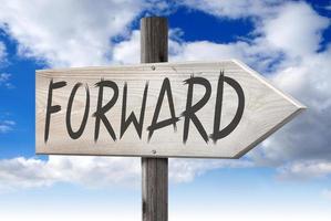 Forward - Wooden Signpost with one Arrow and Cloudy Sky in Background photo