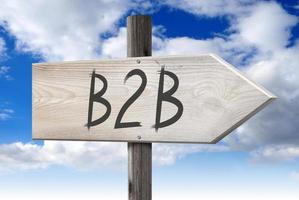 B2B, Business To Business - Wooden Signpost with one Arrow and Cloudy Sky in Background photo