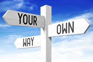 Your Own Way - Wooden Signpost with Three Arrows and Sky in Background photo