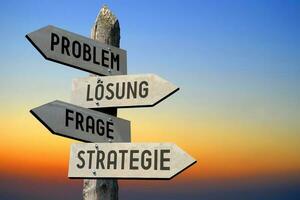 Problem, Solution, Question and Strategy in German - Wooden Signpost photo