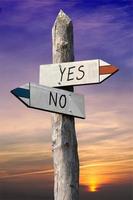 Yes or No - Signpost with Two Arrows, Sunset Sky in Background photo