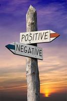 Positive or Negative - Signpost with Two Arrows, Sunset Sky in Background photo