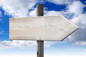 Empty Wooden Signpost with one Arrow with Cloudy Sky in Background photo