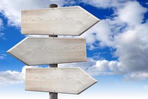 Empty Wooden Signpost with Three Arrows with Cloudy Sky in Background photo