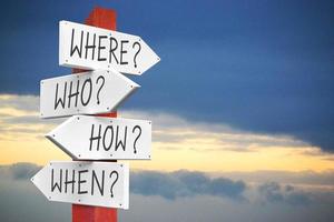 Where, Who, How, When - Questions - Wooden Signpost with Four Arrows photo