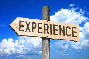 Experience - Wooden Signpost with one Arrow, Sky with Clouds in Background photo