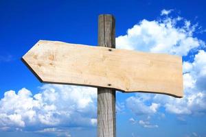 Wooden Signpost with one Clear Arrow, Sky with Clouds in Background photo