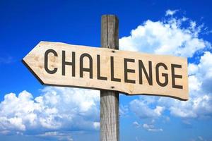 Challenge - Wooden Signpost with one Arrow, Sky with Clouds in Background photo