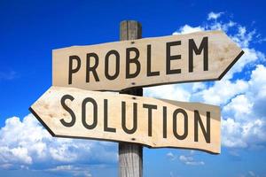 Problem, Solution - Wooden Signpost with Two Arrows, Sky with Clouds in Background photo