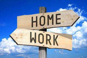 Home, Work - Wooden Signpost with Two Arrows, Sky with Clouds in Background photo