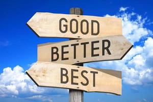 Good, Better, Best - Wooden Signpost with Three Arrows, Sky with Clouds in Background photo