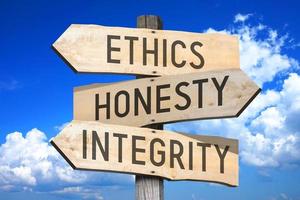 Ethics, Honesty, integrity - Wooden Signpost with Three Arrows, Sky with Clouds in Background photo