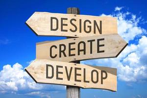 Design, Create, Develop - Wooden Signpost with Three Arrows, Sky with Clouds in Background photo