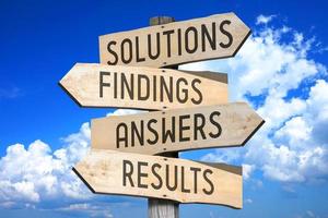 Solutions, Findings, Answers, Results - Wooden Signpost with Four Arrows, Sky with Clouds in Background photo