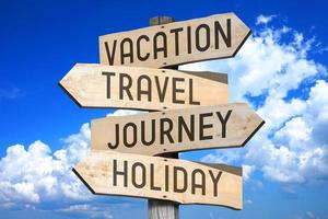 Vacation, Travel, Journey, Holiday - Wooden Signpost with Four Arrows, Sky with Clouds in Background photo