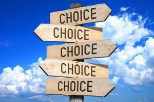 Choice - Wooden Signpost with Five Arrows, Sky with Clouds in Background photo