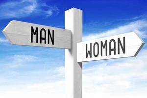 Man, Woman - Wooden Signpost with Two Arrows and Sky in Background photo