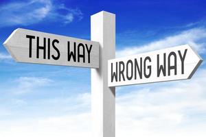 This Way, Wrong Way - Wooden Signpost with Two Arrows and Sky in Background photo