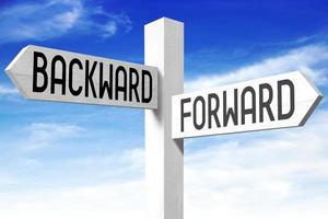 Forward, Backward - Wooden Signpost with Two Arrows and Sky in Background photo