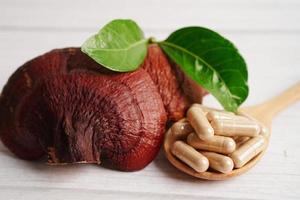 Lingzhi or Reishi mushroom with capsules, organic natural healthy food. photo