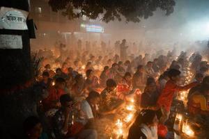 Narayanganj, Dhaka, Bangladesh, on November 12, 2022, Devotees offering prayers at the Shri Shri Lokanath Brahmachari Ashram temple during the Hindu religious fasting festival of Rakher Upobash. photo