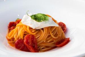 Italian pasta - spaghetti with stracciatella cheese closeup, mediterranean diet. photo