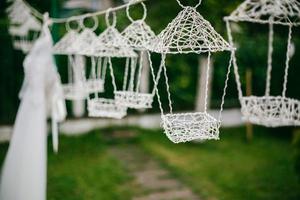 Wedding decor, candles in glass flasks in the forest. photo