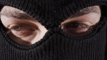 Close-up masked assassin, soldier or thief. Close-up of man in ski mask. video