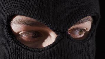 Close-up masked assassin, soldier or thief. Close-up of man in ski mask. video