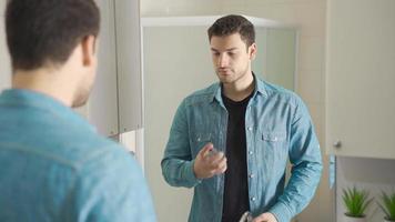 Squeeze perfume. Personal care Handsome man sprays perfume on himself in front of the mirror. video