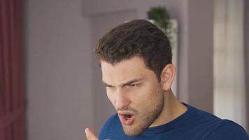 Bad breath. The man opens his mouth and smells his mouth and is disgusted. video