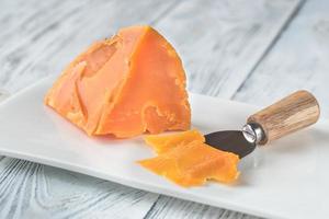 Mimolette cheese on white plate photo