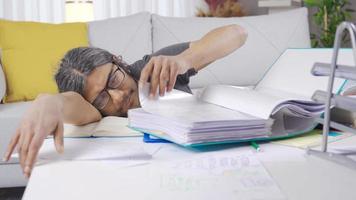 Funny bored businessman falling asleep at the table at home, sleepy. Lazy businessman falls asleep while working at home. video