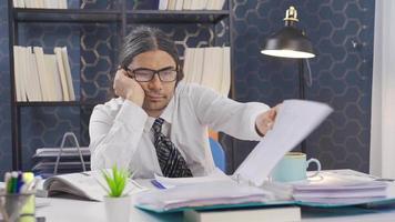 Lazy office worker sitting at desk distracted and pensive. Office worker sitting at desk is not interested in work and is distracted. video