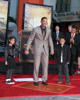 Will Smith with his kids Willow  JadenWill Smith Handprint and Footprint Ceremony Graumans Chinese Theater ForecourtDecember 10 2007Los Angeles CA2007 photo