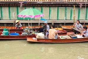 The boat that sells seafood - at Damnoen Floating Market is a popular tourist attraction for tourists. It is a traditional way of life of the villagers. - 10 - 8 - 2014 - Damnoen Saduak Ratchaburi. photo