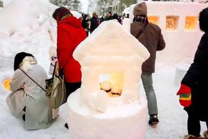 Hakodate, Hokkaido, Japan, 2018  Many people and tourist let come to visit snow candles in the Otaru Snow Light Path Festival at Otaru, Hokkaido prefecture, Japan. photo