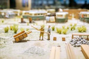 Japanese workers in miniature models of 1800's on blurry ancient worker camps. Show in The Osaka Museum of History, Osaka prefecture, Japan. photo