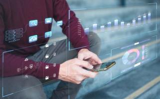 Analyst working with Business Analytics and Data Management System ,man sitting outdoor using smartphone with virtual graph data. Corporate strategy for finance, operations, sales, marketing. photo