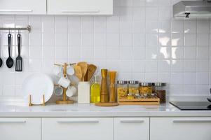 Kitchen utensils and kitchenware on white countertop at home photo