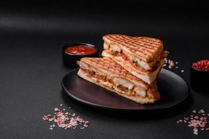 Delicious crispy sandwich with chicken breast, tomatoes, ketchup and spices photo